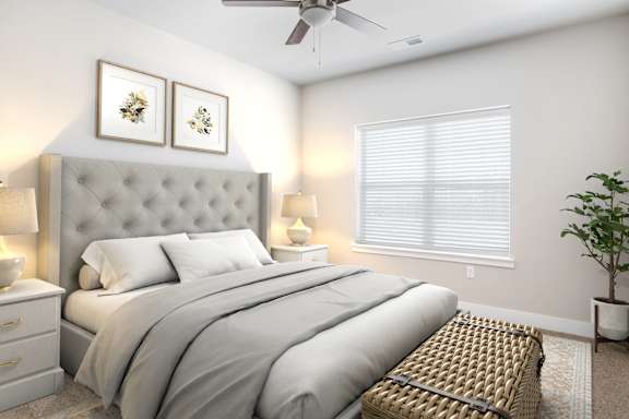 A bedroom with a large bed and a ceiling fan.