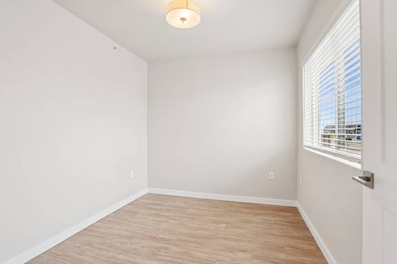 A room with a window and a door.