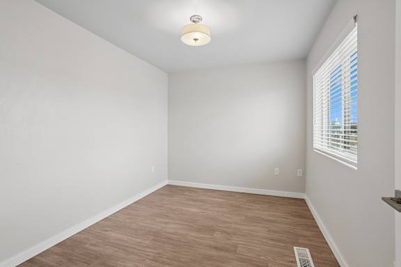 A room with a window and a light on the ceiling.