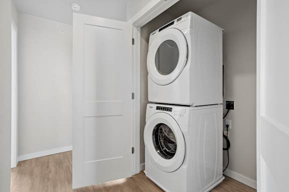 A white washing machine and dryer in a small room.
