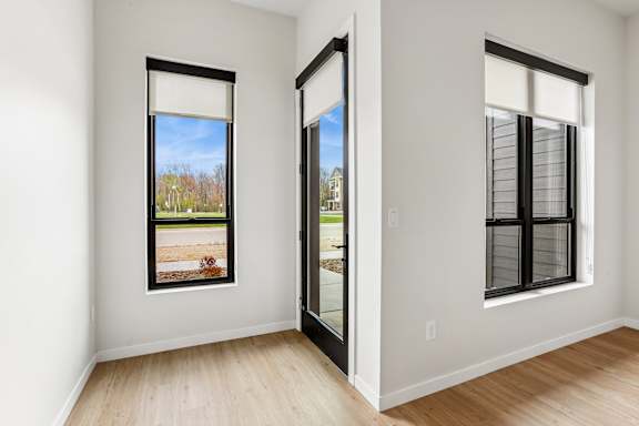 A room with a large window and a door.