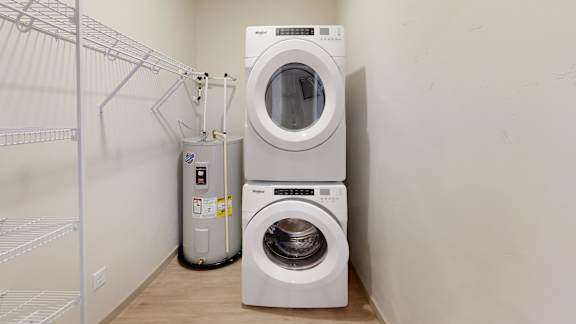 A white washing machine and dryer in a laundry room.