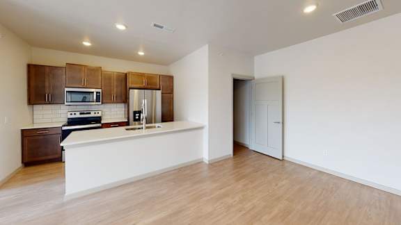 A kitchen with wooden cabinets and a white countertop.