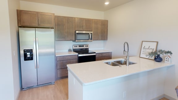 Kitchen with stainless steel appliances, quartz countertops