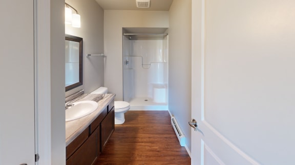 a bathroom with a toilet and a sink and a shower