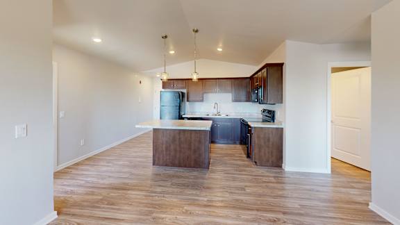 Floor Plan  A kitchen with a wooden floor and white walls.