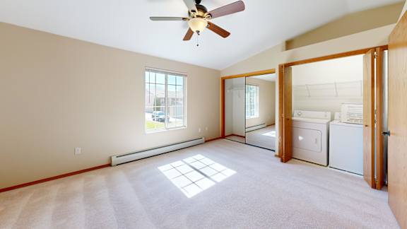 A room with a ceiling fan and a window.