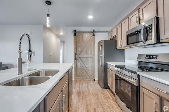 A kitchen with wooden cabinets and stainless steel appliances.