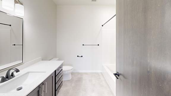 A bathroom with a toilet, sink, and shower.