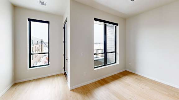 A room with a window and a door.