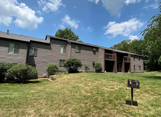 a building with a grassy yard in front of it