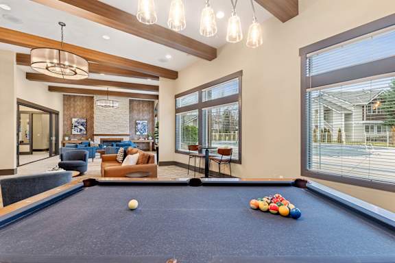 A pool table with a white ball and some colorful balls on it.
