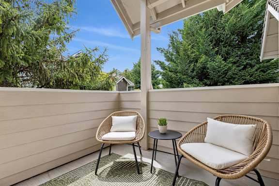 A patio with two chairs and a table.