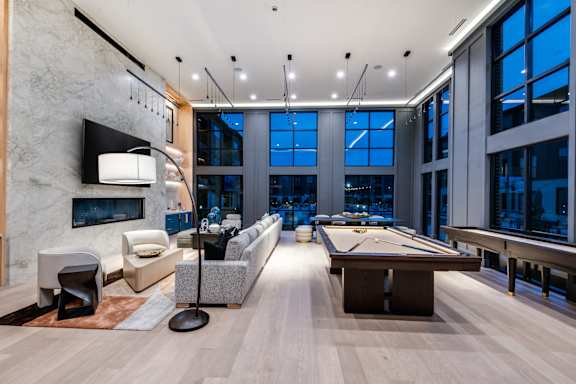 A room with a pool table and a television.
