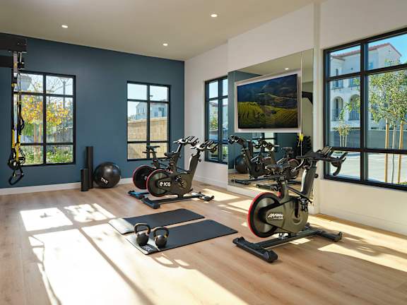 A gym with exercise equipment and a large window.