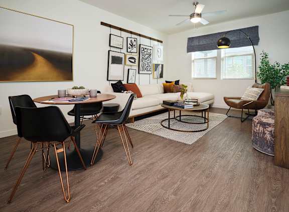 A modern living room with a dining table and chairs.