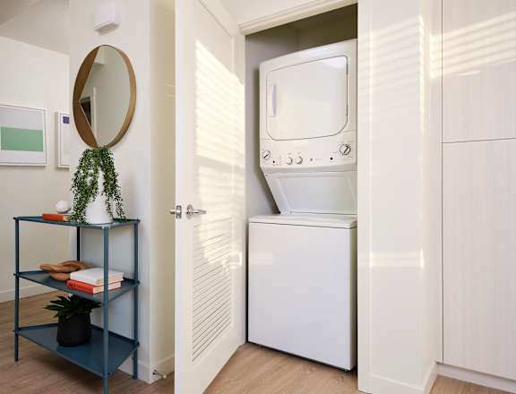 A white oven is built into a white cabinet in a kitchen.