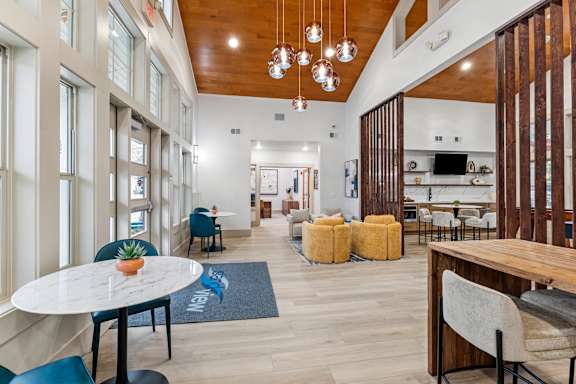 A modern dining area with a round table and chairs.