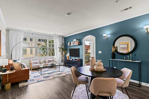 A modern living room with a black table and chairs.
