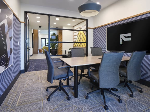 a conference room with a table and chairs
