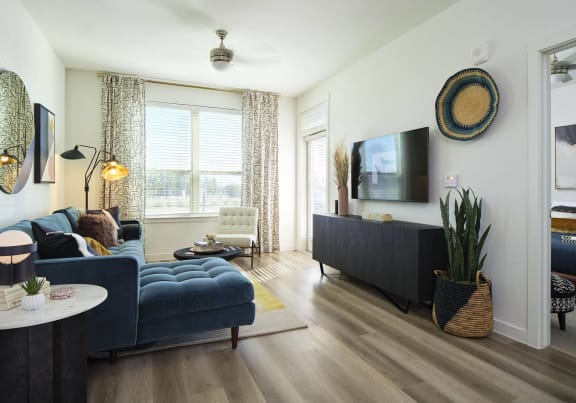 a living room with a blue couch and a tv