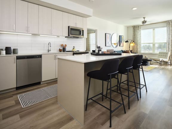 a kitchen with an island and bar stools