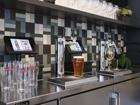 a bar with pitchers of beer and glasses on it