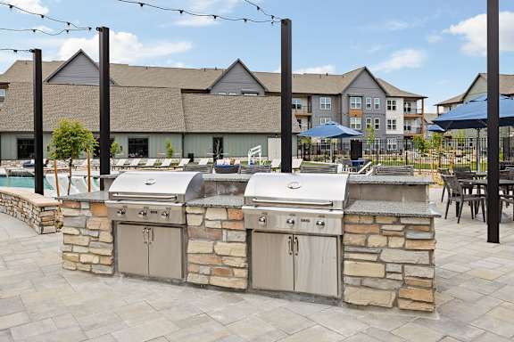 A stone wall with two grills on it.