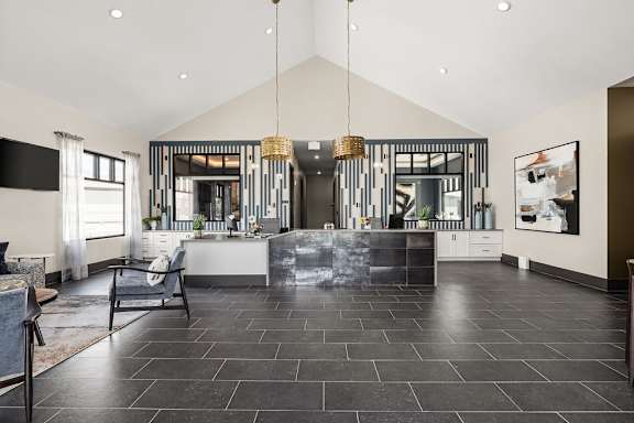 A modern kitchen with a black floor and a large island.
