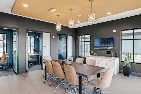 A conference room with a long table and chairs.