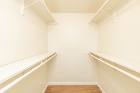 Empty room with white walls and wooden floor.