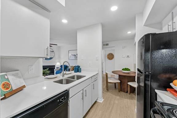 Kitchen with white quartz countertops and dining nook at Knoll Crest Apartments, Texas, 78240