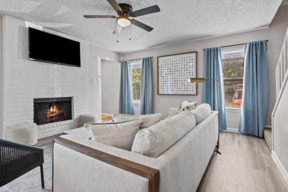 a living room with a couch and a fireplace&#xA0;at Maxwell Townhomes, San Antonio, TX, 78230
