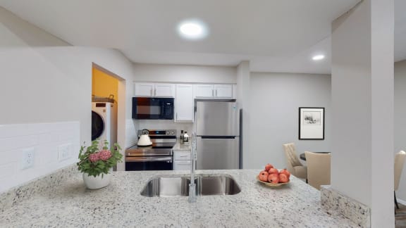 a kitchen with granite countertops and stainless steel appliances at The Frederick, Texas, 78240