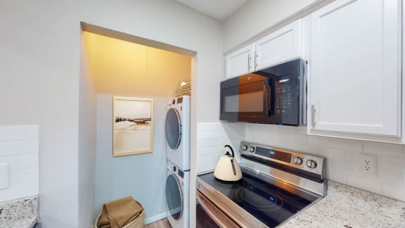 a laundry room with a washer and dryer at The Frederick, Texas