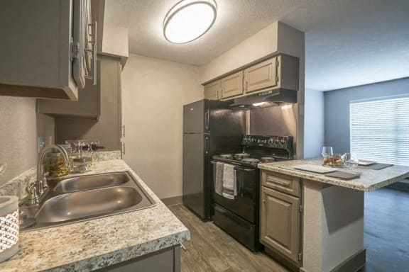 a kitchen with stainless steel appliances and granite counter tops at Rock 35, Round Rock
