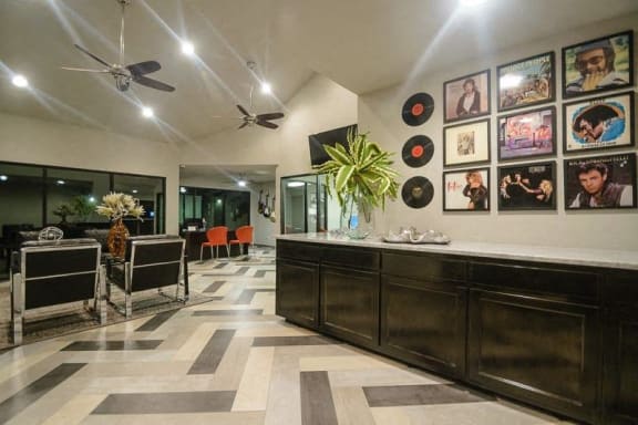 a lobby with a bar and a table with chairs at Rock 35, Round Rock, TX