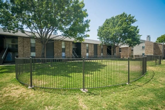 a wrought iron fence in front of an apartment building at Rock 35, Round Rock, 78681