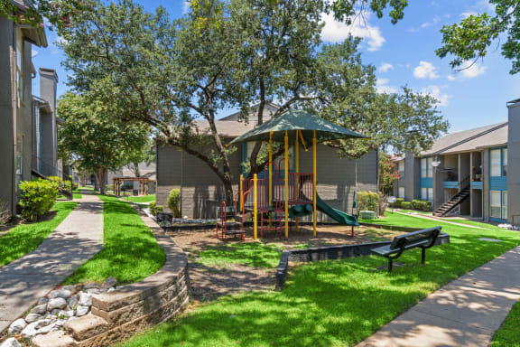 our apartments offer a park with a playground  at Vesper, Dallas, TX, 75254