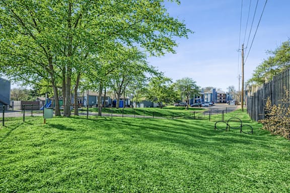 A park with a green lawn and trees.