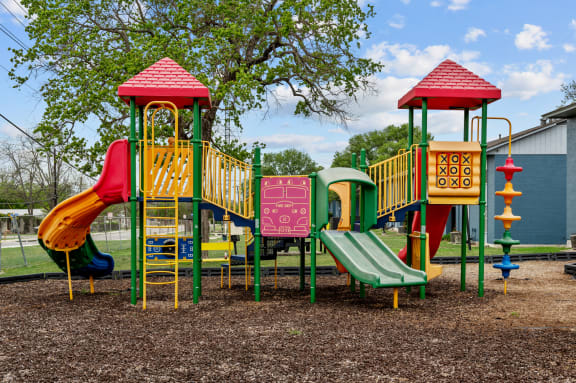 a colorful playground with slides and climbers at Sunset Heights, San Antonio, 78209