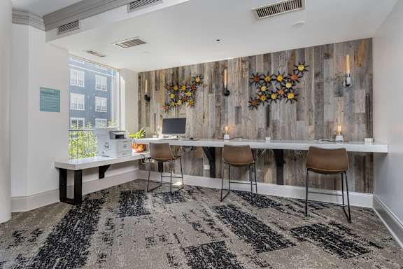 A room with a wooden wall and a black and white rug.