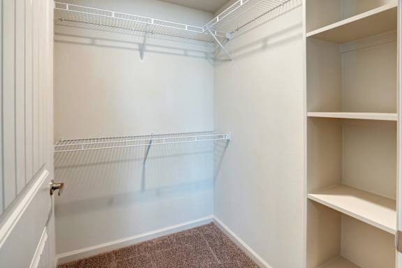 Walk-in closet with upper and lower wire shelving at High Point Preserve Apartments, Austin, TX