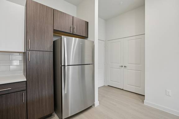 Kitchen with stainless refrigerator and pantry storage 1 at Cantarra Apartments, Manor, 78653
