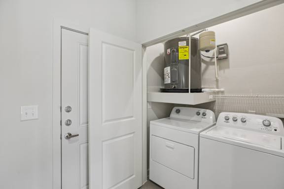 Laundry closet with side by side washer and dryer 2 at Cantarra Apartments, Manor, Texas
