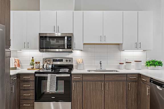 A modern kitchen with a stainless steel oven and microwave.