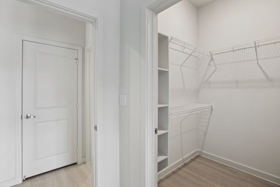 Walk-in closet with wire shelving and builtin storage 1 at Cantarra Apartments, Texas, 78653
