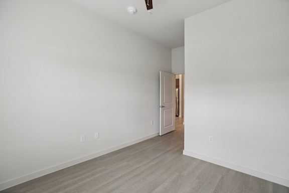 Empty bedroom with open door to hallway 1 at Cantarra Apartments, Manor, 78653