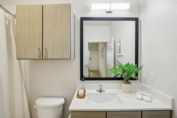 Bathroom vanity with black framed mirror at Matador Apartments, Austin, TX 78745