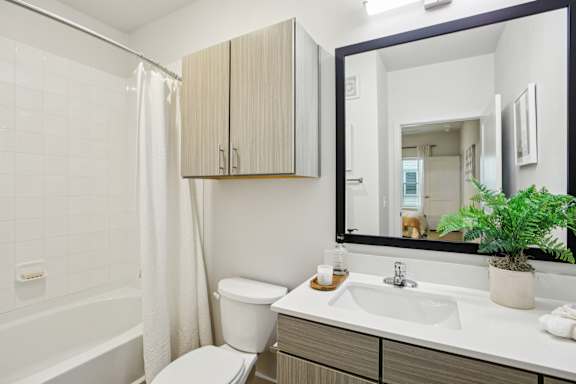 Bathroom with black framed mirror at Matador Apartments, Austin, TX